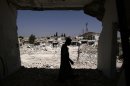 A Syrian man walks in his house which was destroyed in a Syrian government forces shelling, over looking the rubble of other houses, in Azaz, on the outskirts of Aleppo, Syria, Wednesday, Aug. 29, 2012. (AP Photo/Muhammed Muheisen)
