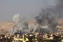 Smoke rises during clashes in the town of Bashiqa, east of Mosul, during an operation to attack Islamic State militants in Mosul