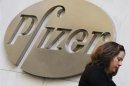 A woman walks past the Pfizer Inc. headquarters in New York