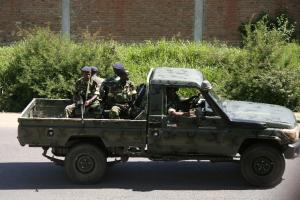 Military personnel sit aboard a vehicle driving through &hellip;