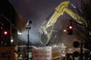 An excavator clears debris at the site of a building explosion in the Harlem section of New York