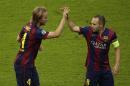 Barcelona's Ivan Rakitic, celebrates with Andres Iniesta scoring the opening goal during the Champions League final soccer match between Juventus Turin and FC Barcelona at the Olympic stadium in Berlin Saturday, June 6, 2015. (AP Photo/Michael Sohn)