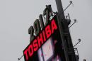 FILE PHOTO - Workers prepare the new year's eve numerals above a Toshiba sign in Times Square in Manhattan, New York City, U.S.