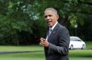 U.S. President Barack Obama points as he walks on the South Lawn of the White House