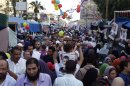 Members of the Muslim Brotherhood and supporters of deposed Egyptian President Mursi walk with their families in the sit-in area of Rab'a al- Adawiya Square