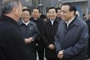 China's Vice-Premier Li Keqiang talks with a resident during his visit to an affordable housing neighbourhood in Langfang