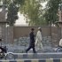 Pakistani men walk by the Central Jail in Peshawar, Pakistan, Wednesday, May 23, 2012. A Pakistani doctor who helped the U.S. track down Osama bin Laden was sentenced to 33 years in prison on Wednesday for conspiring against the state, officials said, a verdict that is likely to further strain the country's relationship with Washington. (AP Photo/Mohammad Sajjad)