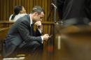 Olympic and Paralympic track star Oscar Pistorius sits in the dock during the fifth day of his trial for the murder of his girlfriend Reeva Steenkamp at the North Gauteng High Court in Pretoria