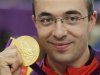 Romania's Alin George Moldoveanu poses with his gold medal during the 10m air rifle men's victory ceremony at the Royal Artillery Barracks during the London 2012 Olympic Games