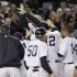 New York Yankees' Raul Ibanez celebrates with teammates as he reaches home plate after hitting the game-winning home run during the 12th inning of Game 3 of the American League division baseball series against the Baltimore Orioles on Wednesday, Oct. 10, 2012, in New York. The Yankees 3-2. (AP Photo/Kathy Willens)