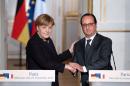 French President Francois Hollande (R) shakes hands with German Chancellor Angela Merkel after a joint press conference at the Elysee presidential palace in Paris, on November 25, 2015