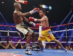 Manny Pacquiao lands a punch on Floyd Mayweather during their welterweight fight Saturday. (Reuters)