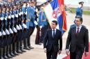 French Prime Minister Manuel Valls (C) and his Serbian counterpart Aleksandar Vucic (R) review the honour guard prior to a meeting in Belgrade on November 6, 2014