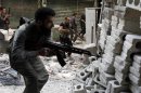 Members of the Free Syrian Army take positions as they return fire during clashes with pro-government soldiers in the city of Aleppo