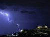 Lightening illuminates the ancient Parthenon temple atop the Acropolis hill in Athens on Sunday Oct. 14, 2012. Greece is inching towards an agreement with its international debt inspectors as they struggle to hammer out the details of euro13.5 billion ($17.5 billion) in austerity measures for the next two years, a package essential for Greece to receive the next installment of its vital bailout funds. (AP Photo/Dimitri Messinis)
