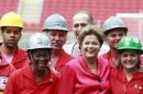 Brazil's President Dilma Rousseff poses with workers during the opening ceremony of the Beira-Rio stadium in Porto Alegre