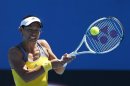 Kimiko Date-Krumm of Japan hits a return to Nadia Petrova of Russia during their women's singles match at the Australian Open tennis tournament in Melbourne