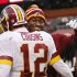Injured Washington Redskins quarterback Robert Griffin III, right, hugs Kirk Cousins (12) after a 38-21 win over the Cleveland Browns in an NFL football game in Cleveland, Sunday, Dec. 16, 2012. Cousins passed for 329 yards and two touchdowns filling in for Griffin. (AP Photo/Rick Osentoski)