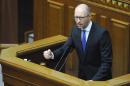Former Ukrainian Prime Minister Arseniy Yatsenyuk gestures as he addresses members of parliament during a parliamentary session in Kiev on July 24, 2014