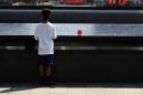 A boy looks at names on the South reflecting pool at the 9/11 Memorial during ceremonies marking the 12th anniversary of the 9/11 attacks on the World Trade Center in New York