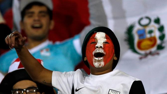 Fans of Peru wearing the national colors cheer their team prior a Copa America Group A soccer match between Venezuela and Peru at the Elias Figueroa stadium in Valparaiso, Chile, Thursday, June 18, 2015. (AP Photo/Jorge Saenz)