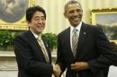 President Barack Obama shakes hands with Japan's Prime Minister Shinzo Abe in the Oval Office of the White House in Washington, Friday, Feb. 22, 2013. (AP Photo/Charles Dharapak)
