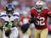 Seattle Seahawks running back Robert Turbin (22) drops a pass in front of San Francisco 49ers linebacker Patrick Willis (52) during the first quarter of an NFL football game in San Francisco, Thursday, Oct. 18, 2012. (AP Photo/Marcio Jose Sanchez)
