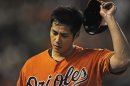 Baltimore Orioles starting pitcher Wei-Yin Chen walks to the dugout after the second inning against the Toronto Blue Jays in their second game of a double header