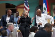 Secretary of State Hillary Rodham Clinton, center, speaks to Haiti's President Michel Martelly, right, during the inauguration of the Caracol Haiti Industrial Park on the outskirts of Cap Hatien, Haiti, Monday, Oct. 22, 2012. Clinton encouraged foreigners to invest in Haiti as she and her husband Bill led a star-studded delegation gathered Monday to inaugurate the new industrial park at the center of U.S. efforts to help the country rebuild after the 2010 earthquake. At left, Haiti's Prime Minister Laurent Lamothe. (AP Photo/Dieu Nalio Chery)