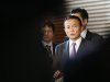 Japan's Finance Minister Aso is seen in-between reporters while he speaks at a joint news conference in Tokyo
