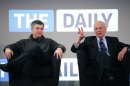 FILE - In this Wednesday, Feb. 2, 2011, file photo, Rupert Murdoch, right, Chairman and CEO of News Corporation, and Eddy Cue, vice president of Apple, attend the launch of The Daily, in New York. News Corp. said it will cease publication of The Daily, on Dec. 15, 2012. News Corp. had hoped The Daily would lure both paying subscribers and advertisers to a digital newspaper that included news, gossip and opinion. (AP Photo/Mark Lennihan)