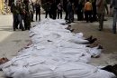 FILE - This file citizen journalism image taken on, Sunday, March. 10, 2013 and provided by Aleppo Media Center AMC which has been authenticated based on its contents and other AP reporting, shows Syrians standing next to dead bodies that have been pulled from the river near Aleppo's Bustan al-Qasr neighborhood, Syria. More than 6,000 people were killed in the Syrian civil war in March alone, according to a leading activist group that reported it was the deadliest month yet in the 2-year-old conflict. (AP Photo/Aleppo Media Center AMC, File)