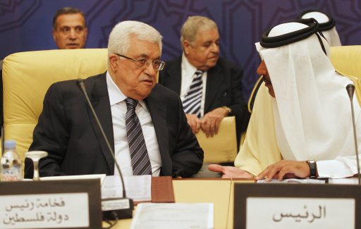 Qatar's Prime Minister and Foreign Minister Hamad bin Jassim bin Jabr Al-Thani speaks with Palestinian President Mahmoud Abbas during the Arab Peace Initiative Committee Meeting in Doha