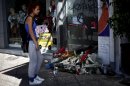 A woman stands on September 19, 2013 in front of the spot where Pavlos Fyssas was murdered, in Piraeus, Greece
