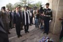 France's President Hollande stands with Mali's interim president Traore before placing flowers in homage to deceased Malian soldiers at the Independence Plaza in Bamako, Mali