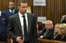 Oscar Pistorius is watched by June Steenkamp, 2nd right, the mother of Reeva Steenkamp, as he arrives for his trial at the high court in Pretoria, South Africa, Monday, March 3, 2014. Pistorius is charged with murder with premeditation in the shooting death of girlfriend Reeva Steenkamp in the pre-dawn hours of Valentine's Day 2013. (AP Photo/Herman Verwey, Media24- Pool)
