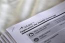 Applications are seen at a rally held by supporters of the Affordable Care Act in Jackson, Mississippi