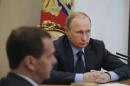 Russian President Putin attends meeting with members of government with PM Medvedev seen in foreground in Moscow