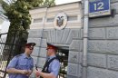 Russian policemen stand outside the embassy of Ecuador in Moscow