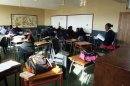 A group of pupils sit in an empty geography class at St Mark's High School in Mbabane on July 24