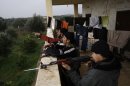 In this Monday, Dec. 17, 2012 photo, Syrian rebels prepare themselves before attending a training session in Maaret Ikhwan, near Idlib, Syria. The training is part of an attempt to transform the rag-tag rebel groups into a disciplined fighting force. (AP Photo/Muhammed Muheisen)