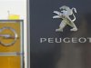 The logos of German General Motors daughter Opel and French car maker Peugeot are seen at a Opel and Peugeot dealership in Leverkusen