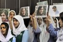 Pakistani students sing as they hold pictures of 14-year-old schoolgirl Malala Yousufzai, who was shot last Tuesday by the Taliban for speaking out in support of education for women, during a tribute at the Pakistani Embassy in Abu Dhabi, United Arab Emirates, Monday, Oct. 15, 2012. Pakistan airlifted a 14-year-old activist who was shot and seriously wounded by the Taliban to the United Kingdom for treatment Monday, a move that will give her access to the specialized medical care she needs to recover and also protect her from follow-up attacks threatened by the militants. (AP Photo/Kamran Jebreili)