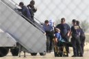 A JetBlue pilot is removed from the plane after erratic behavior forced the crew to land in Amarillo Texas