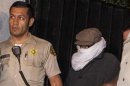 File photo of Nakoula Basseley Nakoula escorted out of his home by Los Angeles County Sheriff's officers in Cerritos, California