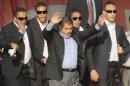 Flanked by bodyguards, Egypt's Islamist president-elect Mohamed Morsi salutes tens of thousands of Egyptians