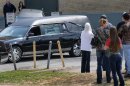 A hearse leaves the Municipal Auditorium in Charleston, W.Va. after a joint funeral for "Buckwild" star Shain Gandee and his uncle David Gandee Sunday afternoon, April 7, 2013. Gandee, his 48-year-old uncle, David Gandee, and 27-year-old friend Donald Robert Myers were found dead April 1 in a sport utility vehicle that was partially submerged in a deep mud pit near Sissonville. (AP Photo/The Charleston Gazette, Kenny Kemp)