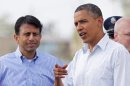 President Barack Obama speaks with Louisiana Gov. Bobby Jindal as he arrives at Louis Armstrong New Orleans International Airport in Kenner, La., Monday, Sept. 3, 2012. (AP Photo/Jonathan Bachman)