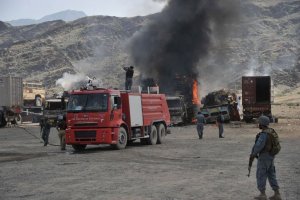 Afghan security personnel guard burning military vehicles …