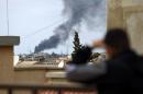 Smoke rises from the port of the eastern Libyan city of Benghazi on February 14, 2015 during clashes between forces loyal to the internationally recognised government and Islamist militias